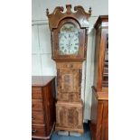 A 19th century flame mahogany crossbanded longcase clock with 12 1/2 inch painted arch top dial