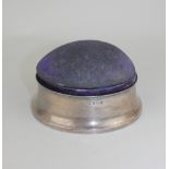 A George V silver mounted circular dressing table box with domed fabric lid and fitted interior