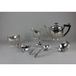 A silver plated three-piece tea set of demi fluted oval form, three-piece cruet set, soup ladle