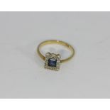 A sapphire and diamond cluster ring, set in 18ct gold
