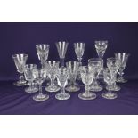 A collection of 19th century and later drinking glasses, most with fluted bowls, some with deceptive