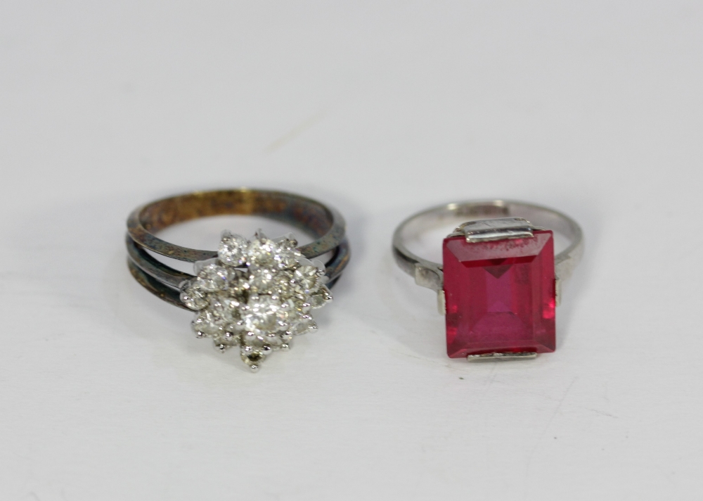A synthetic ruby ring, in white 9ct gold and a silver white stone cluster ring