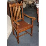 An oak carver chair with drop-in upholstered seat on spiral twist supports