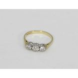 A diamond graduated three stone ring, in 18ct gold