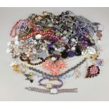 A quantity of costume jewellery and ladies watches to include shell and bead necklaces, brooches