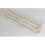 Two cultured white pearl necklaces, strung knotted, with white metal clasps, both 46cm