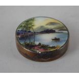 A George V silver and guilloche enamel circular compact the lid decorated with a mountainous lake