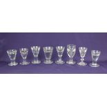 A collection of eight 19th century and later penny lick and toastmaster's glasses with deceptive