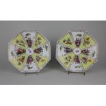 A pair of Dresden porcelain octagonal plates decorated with panels of courting couples and flowers