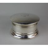 An early 20th century silver circular dressing table box with domed hinged top with mirror inset