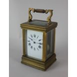 A French brass carriage clock the white enamel dial with Roman numerals inscribed 'Anglo Swiss Watch