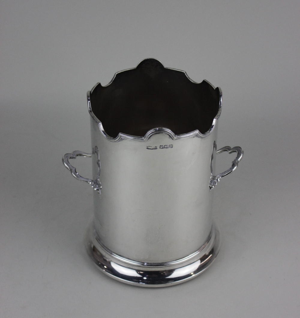 A George V silver two-handled bottle coaster tall cylindrical form with scalloped rim on turned