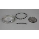 A silver retractable toothpick two silver bangles and an Austrian coin pendant