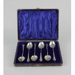 A cased set of six Edward VII silver coffee spoons with gilt bowls and turned handles, maker William