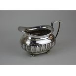 A George V silver cream jug oval demi fluted form, maker Walker and Hall, Sheffield 1917, 7oz