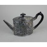 An 18th century silver teapot oval shape with later embossed floral and scroll decoration,