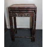 A nest of two Chinese carved hardwood tables with rectangular top above pierced border on slender