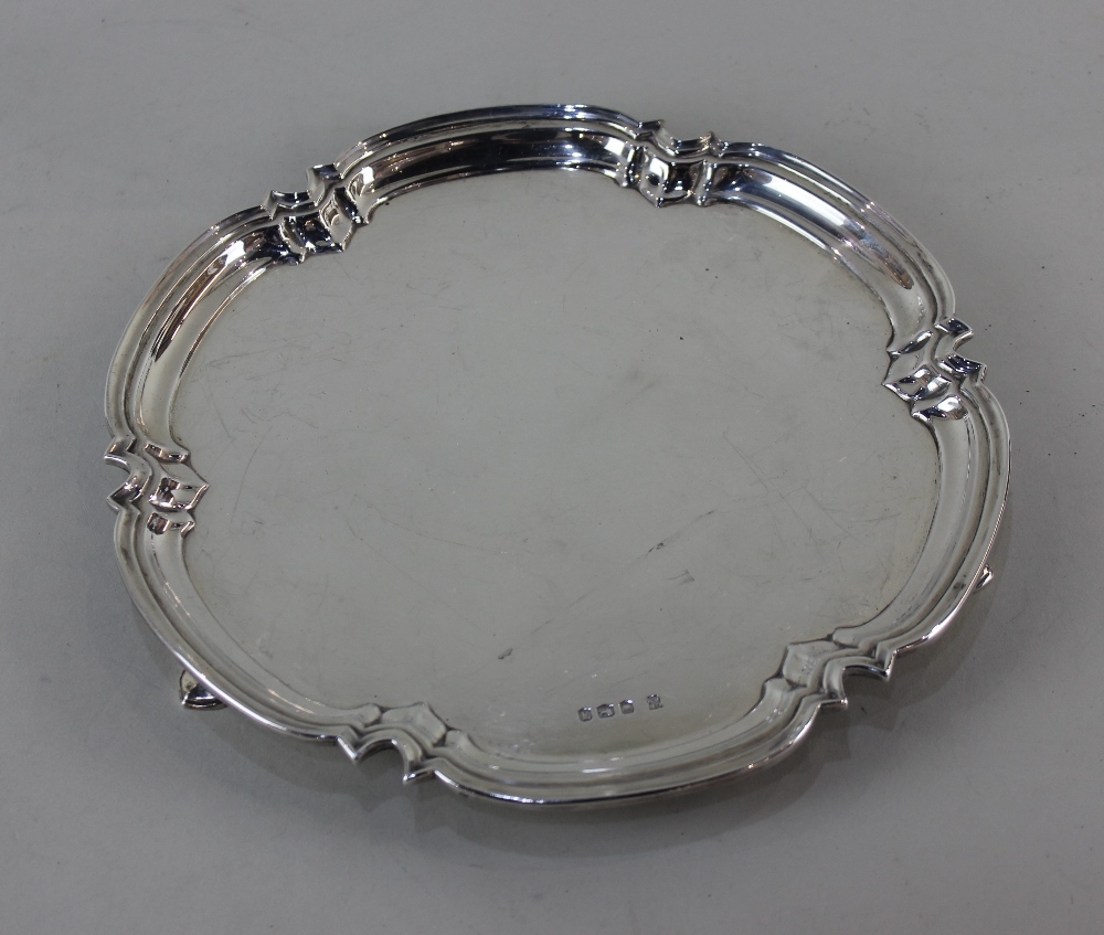 A modern silver salver lobed piecrust border on three hoof feet, maker Cooper Brothers & Sons,