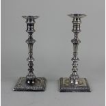 A pair of George III silver candlesticks baluster shape with detachable drip trays, on square