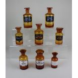 A collection of eight amber glass apothecary jars to include Tinct. Digital. and Tinct. Strophant.