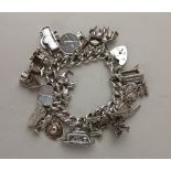 A silver charm bracelet with silver heart shaped padlock clasp set with twenty four silver and white