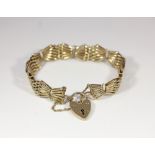 A 9ct gold gatelink bracelet with padlock, 20.8g