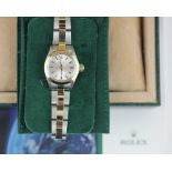 A lady's Rolex Oyster Perpetual wristwatch in gold and steel, with fitted case, green suede bag,
