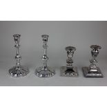 A pair of silver plated baluster candlesticks on lobed circular bases, 23cm and another pair of