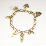 A 9ct gold charm bracelet with 9ct gold padlock clasp and six charms gross weight 24.5g