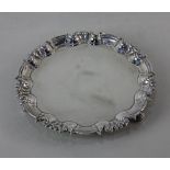 A Victorian silver circular card dish with pie crust border on three scroll feet, maker Wm