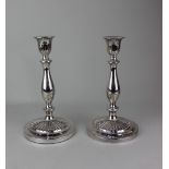 A pair of silver plated candlesticks baluster stems on fluted circular bases, 24cm
