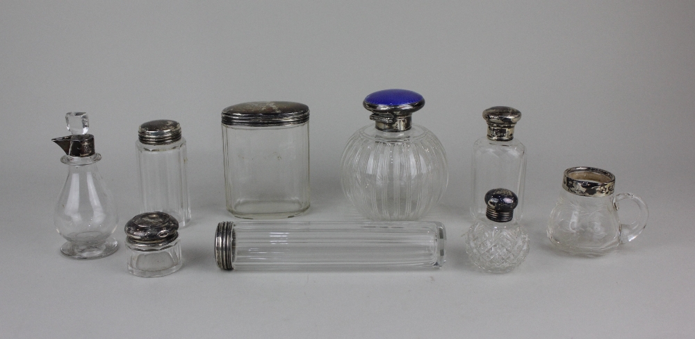 A collection of of nine various silver mounted glass dressing table jar and scent bottles (a/f)