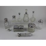 A collection of eight various silver topped glass dressing table jars and scent bottles and a silver