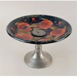 A Moorcroft pottery Pomegranate pattern tazza with hammered pewter base 21.5cm diameter