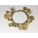 A gold charm bracelet set with a 1914 sovereign, a 1915 sovereign, a 1914 half sovereign and