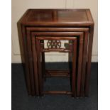 A Chinese hardwood nest of four rectangular tables each with pierced frieze on slender supports with