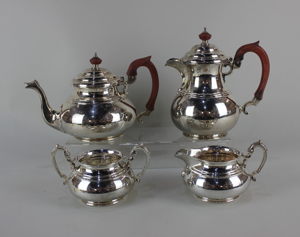 A George V silver four piece tea and coffee set baluster shape with dome lids, to include teapot,