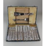 A cased set of six pairs of George V silver handled Kings pattern fish knives and forks and a pair