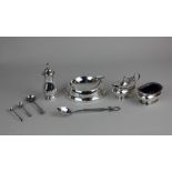 A George V silver three-piece cruet set to include mustard pot and spoon, salt, and pepper pot,