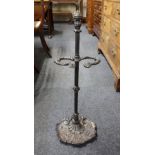 A cast iron umbrella / stick stand with shell form base 74cm high