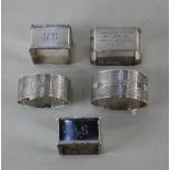 A pair of George V silver square serviette rings with engraved initials, maker Elkington & Co.