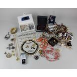 A quantity of costume jewellery to include a Scottish design hardstone brooch, an opal silver