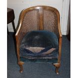 A bergere tub chair with upholstered seat on cabriole front legs