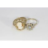 An aquamarine cluster ring in 9ct gold set with white stones and a gold modern cameo style ring in