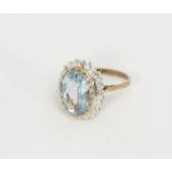 A blue topaz and diamond dress ring, illusion set with 8 spaced diamonds, in 9ct gold