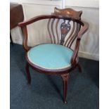 An Edwardian mahogany inlaid salon tub chair with padded oval seat on cabriole legs