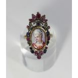 A Georgian giardinetti ring with portrait miniature, set with rubies, sapphires, emeralds and