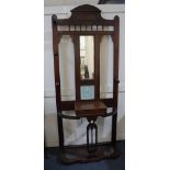 A Victorian mahogany hall stand with open frame central mirror and tile, glove box and two stick