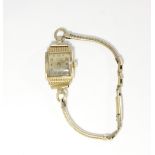 An 18k gold lady's wristwatch square dial marked Ancre with gilt metal bracelet strap,