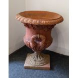 A composite garden urn, terracotta toned 55cm high